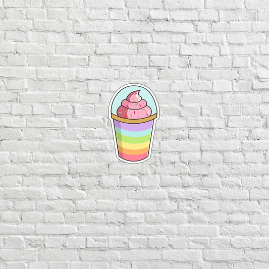 a cupcake sticker on a white brick wall