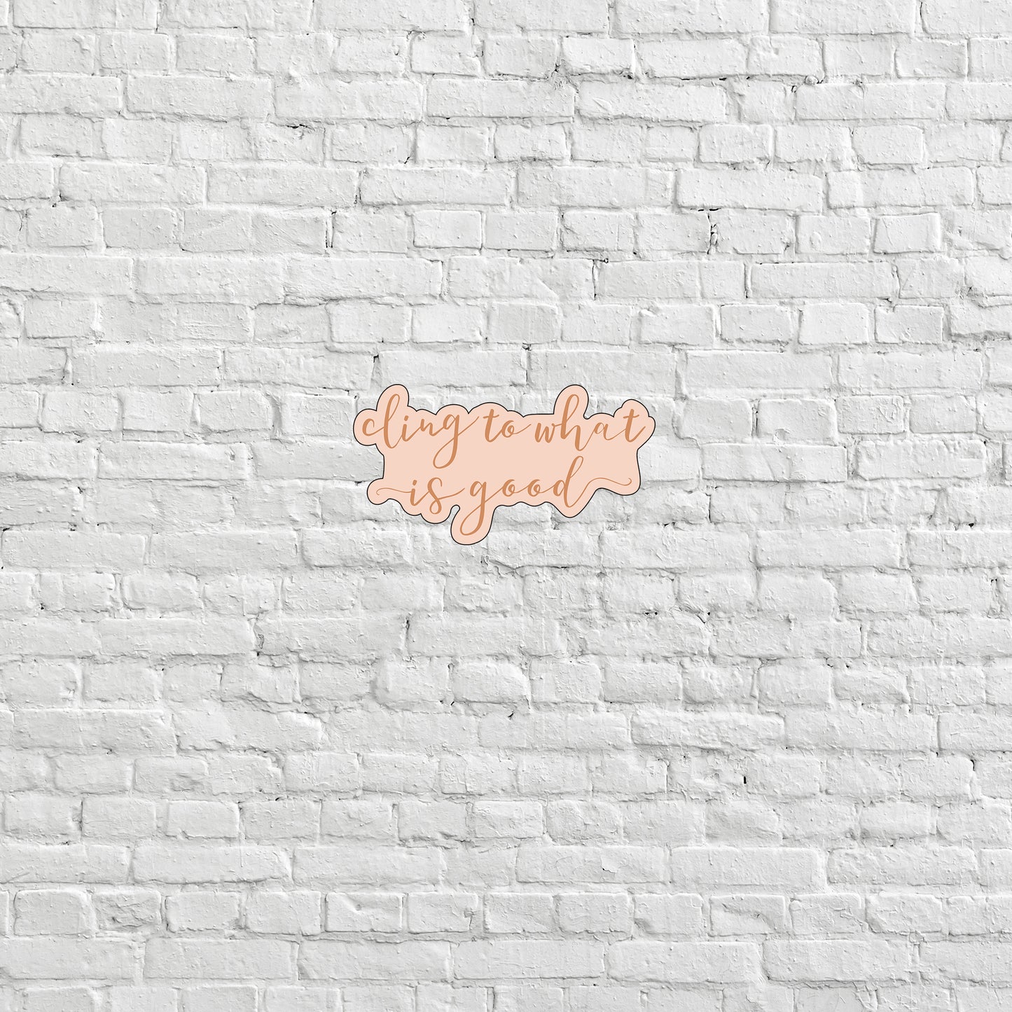 a white brick wall with a pink and orange sign on it