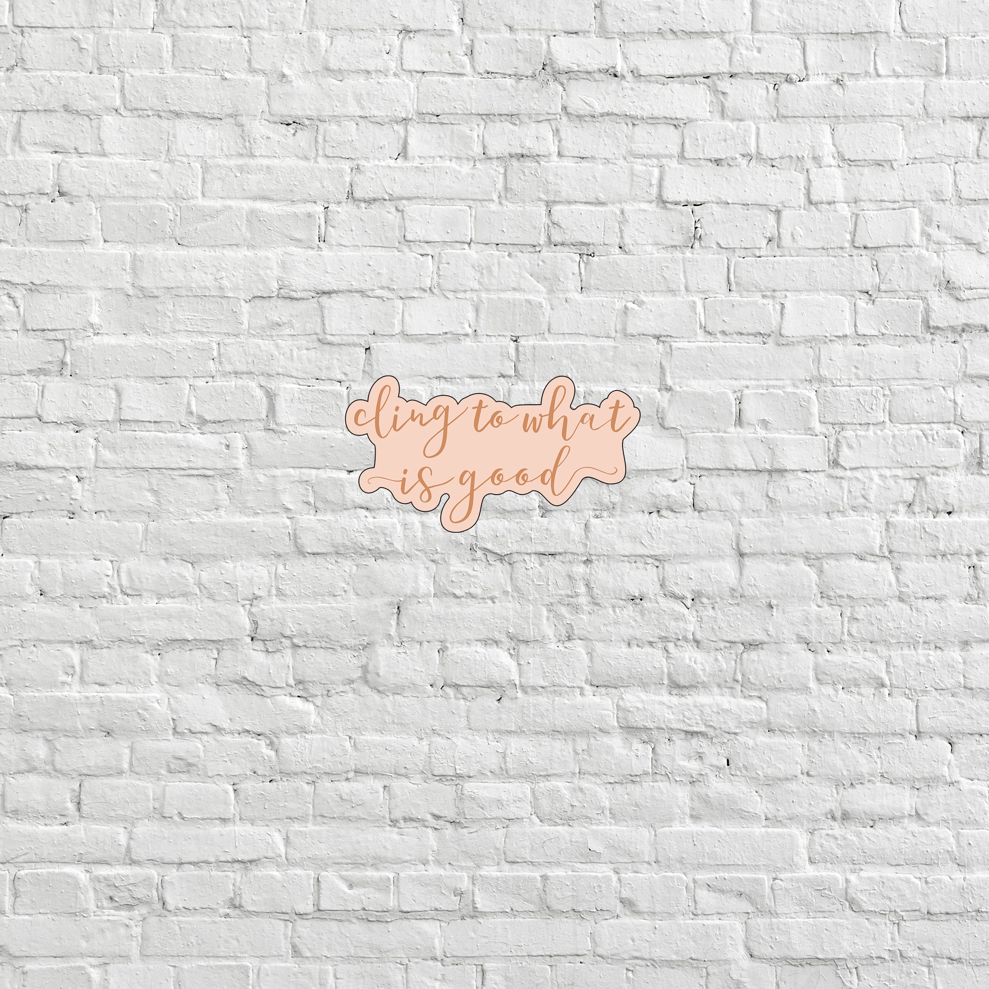 a white brick wall with a pink and orange sign on it